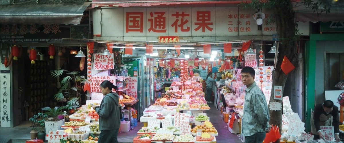Busy fruit and flower stall at a market in Guangzhou