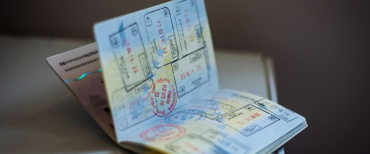 Open passport with multiple travel stamps